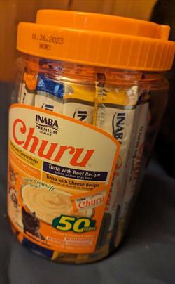 Orange jar of cat treats. 